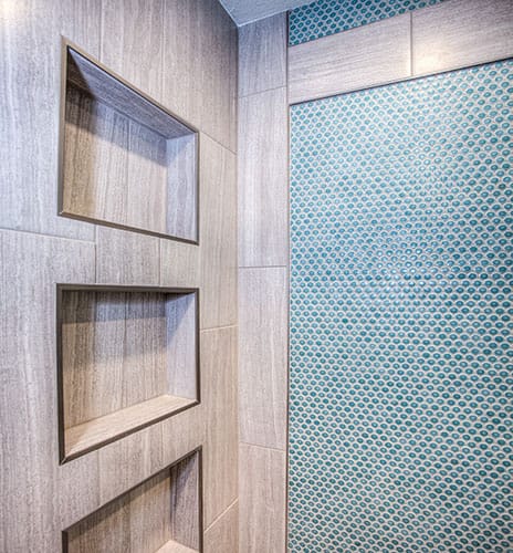 Closeup on ceramic walls and shower niche installed inside a standing shower