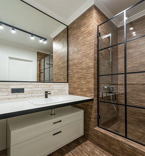Modern bathroom with new vanity and standing shower built inside a MD bathroom
