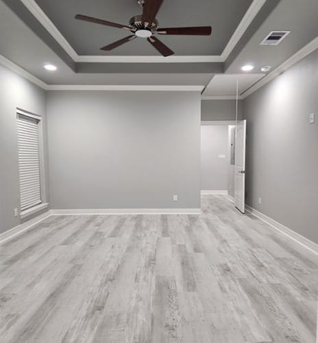 Guest bedroom remodeled with new wooden flooring and fresh painting