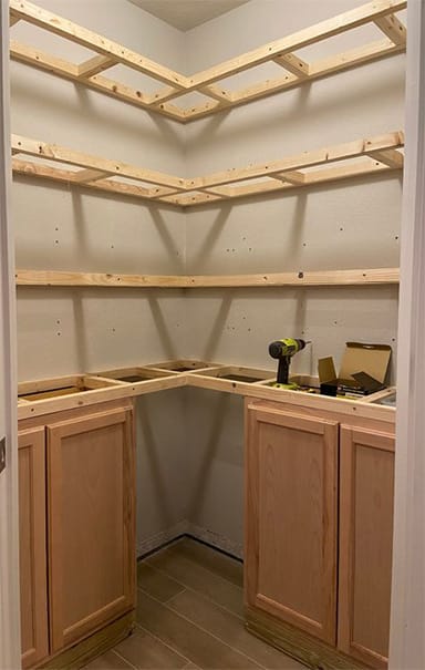 Wooden cabinets and shelves under construction in a closet of a bedroom